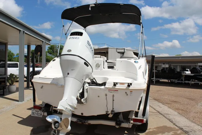 Slide: The Image of 2022 Hurricane SunDeck Sport 192 RL OB boat with outboard motor, parked outdoors. - 12