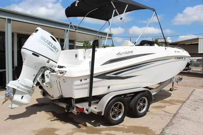 Slide: The Image of 2022 Hurricane SunDeck Sport 192 RL OB boat on trailer with Suzuki outboard motor. - 13