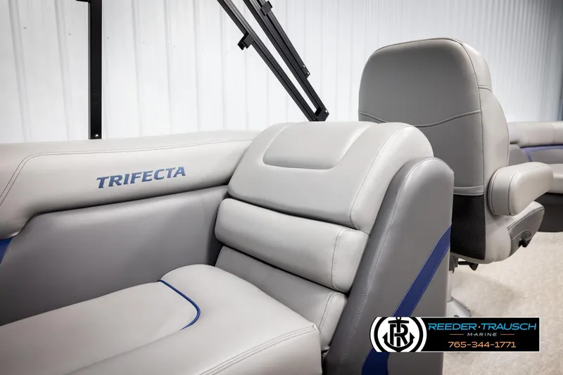 Slide: The Image of 2021 Trifecta 22 CS boat interior with gray seating and logo, Reeder-Trausch Marine branding. - 21