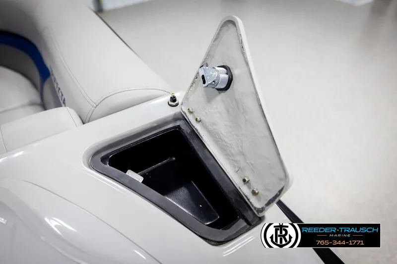 Slide: The Image of 2021 Trifecta 22 CS boat storage compartment with open lid, showcasing interior space. - 24