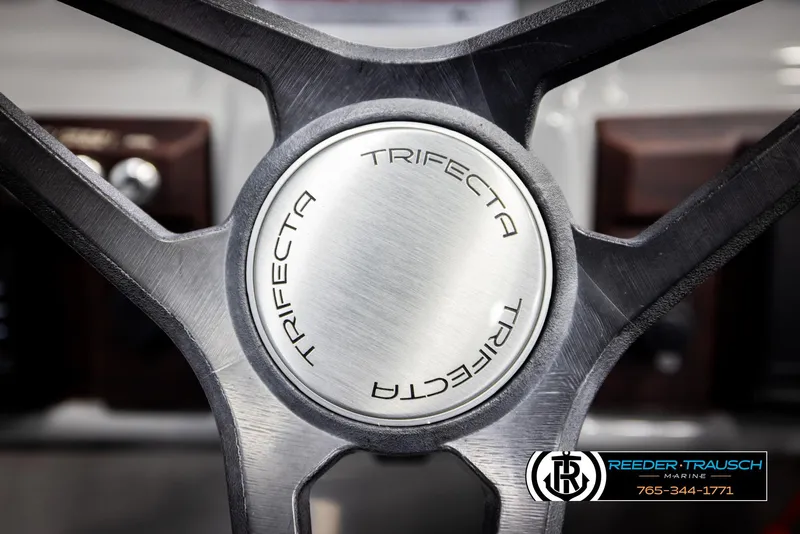 Slide: The Image of Steering wheel of 2021 Trifecta 22 CS boat, featuring sleek metallic design. - 27