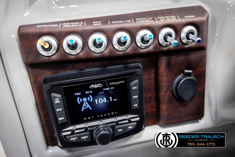 Slide: The Image of Control panel of 2021 Trifecta 22 CS boat with audio system and switches. - 28