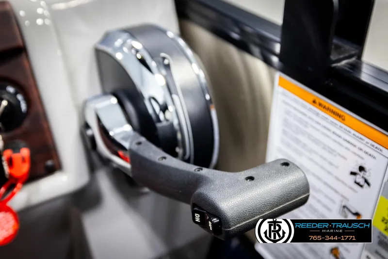 Slide: The Image of Throttle control lever of a 2021 Trifecta 22 CS boat, featuring a sleek design. - 33