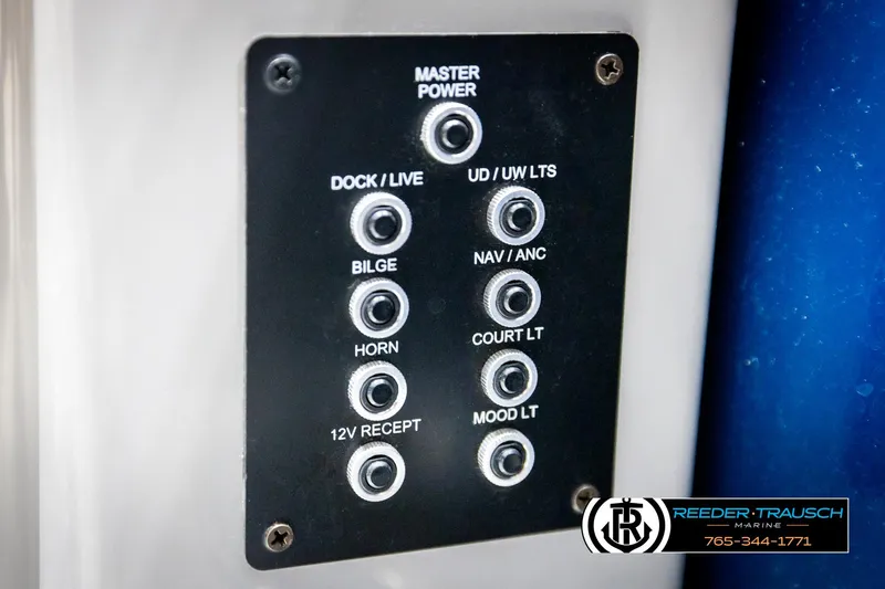 Slide: The Image of Control panel of a 2021 Trifecta 22 CS boat with various switches. - 34