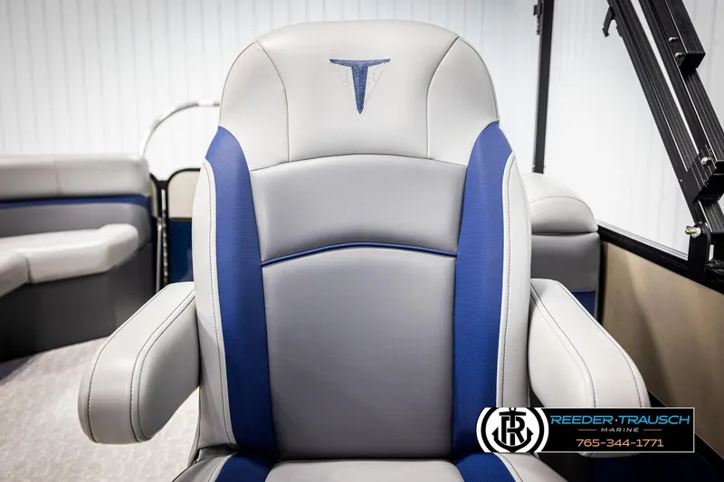 Slide: The Image of 2021 Trifecta 22 CS boat seat with blue accents, featuring Reeder-Trausch Marine logo. - 35