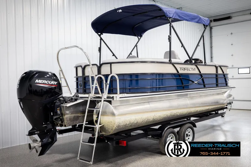 Slide: The Image of 2021 Trifecta 22 CS pontoon boat with Mercury outboard motor in a showroom. - 5