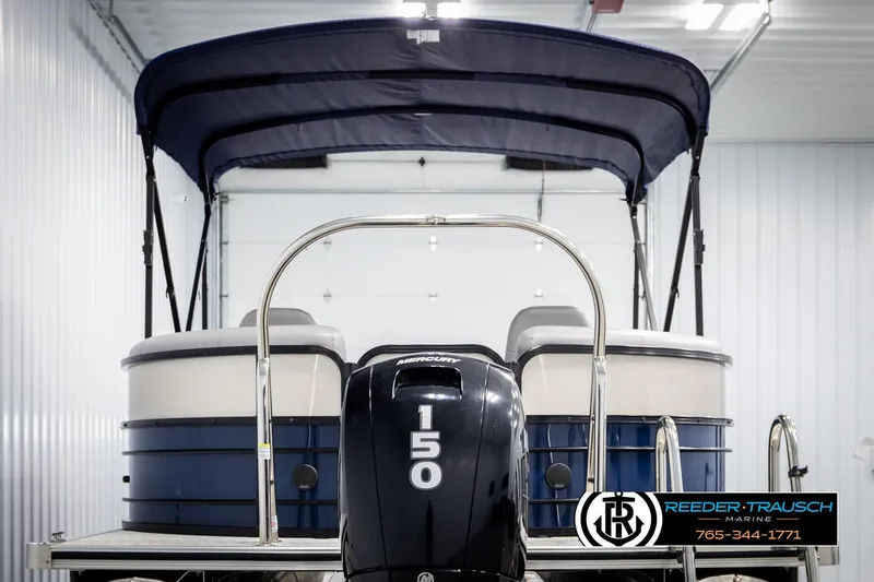 Slide: The Image of 2021 Trifecta 22 CS pontoon boat with 150 HP engine in a showroom. - 6