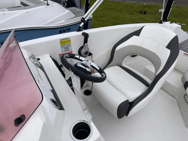 Slide: The Image of 2024 Starcraft 171 SVX boat cockpit with steering wheel and comfortable seating. - 13