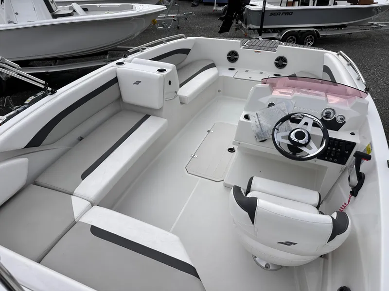 Slide: The Image of 2024 Starcraft 171 SVX boat interior with white seating and modern steering console. - 16