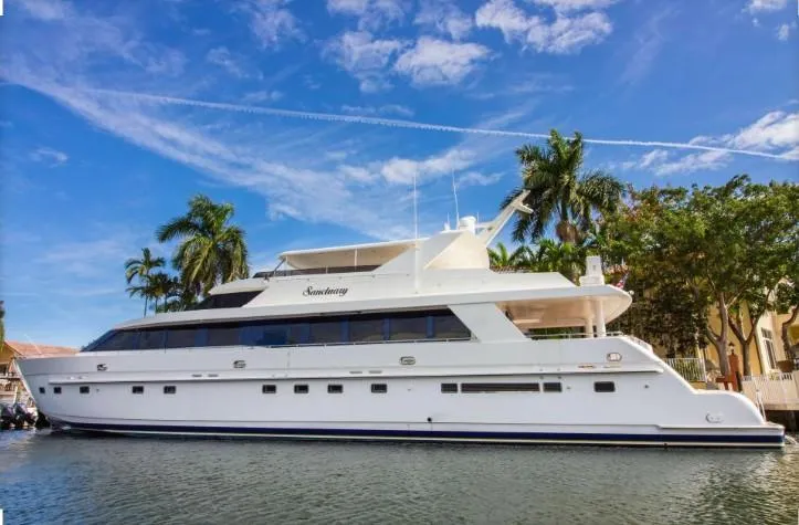 The Image of 2002 Hargrave Raised Pilothouse yacht docked by palm trees under a clear blue sky. - 0