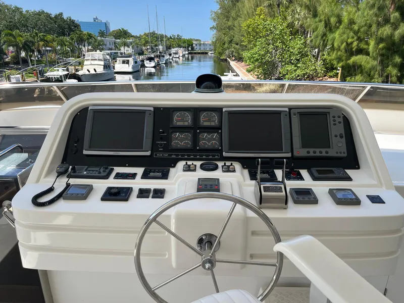 Slide: The Image of 2002 Hargrave Raised Pilothouse yacht helm with navigation instruments and steering wheel. - 12