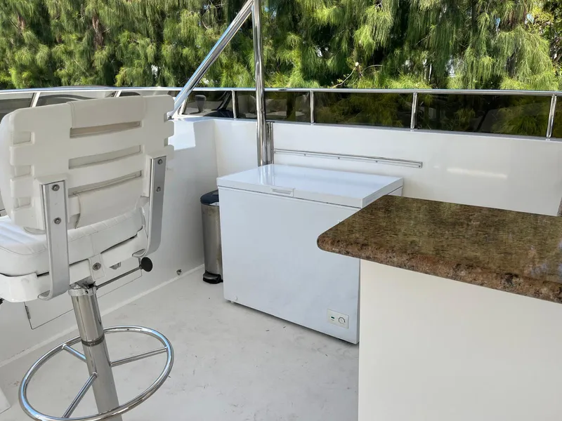 Slide: The Image of 2002 Hargrave Raised Pilothouse yacht deck with chair, counter, and freezer. - 13