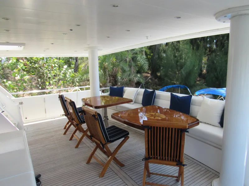 Slide: The Image of Outdoor seating area on 2002 Hargrave Raised Pilothouse yacht with wooden tables and chairs. - 15