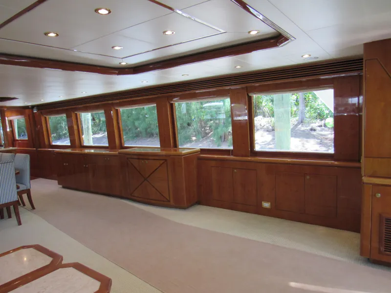 Slide: The Image of Luxurious interior of 2002 Hargrave Raised Pilothouse yacht with large windows and elegant wood finish. - 23