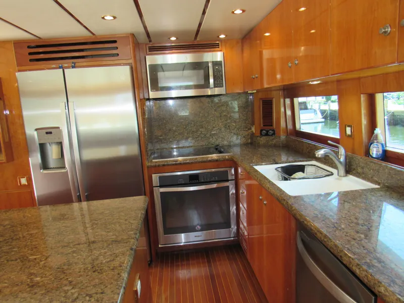 Slide: The Image of Luxurious 2002 Hargrave Raised Pilothouse yacht interior with granite countertop and plush seating area. - 29