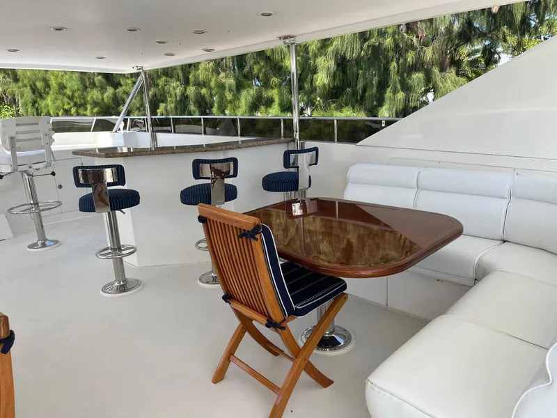 Slide: The Image of Luxurious 2002 Hargrave Raised Pilothouse yacht deck with seating and bar stools. - 3