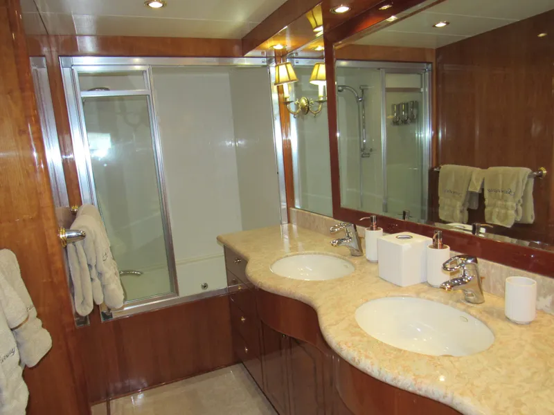 Slide: The Image of Luxurious 2002 Hargrave Raised Pilothouse yacht bedroom with wood paneling and elegant decor. - 38