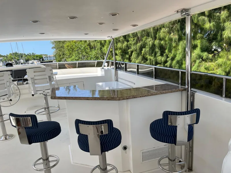 Slide: The Image of Luxurious 2002 Hargrave Raised Pilothouse yacht with elegant outdoor bar and seating area. - 4