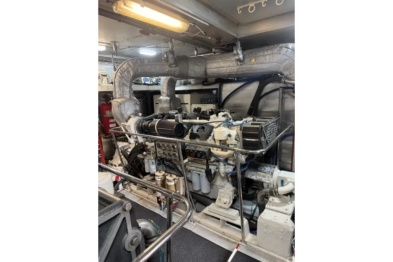 Slide: The Image of Engine room of a 2002 Hargrave Raised Pilothouse yacht, showcasing mechanical components. - 56