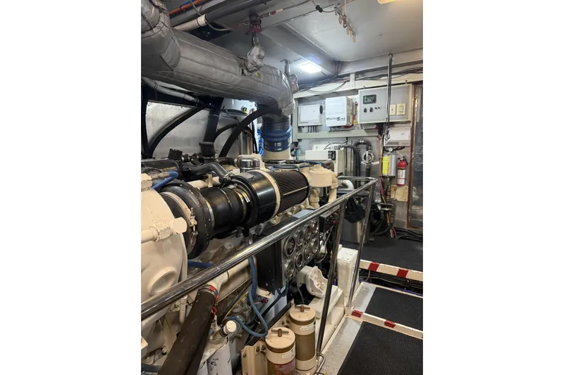 Slide: The Image of Engine room of 2002 Hargrave Raised Pilothouse yacht, showcasing machinery and control panels. - 57