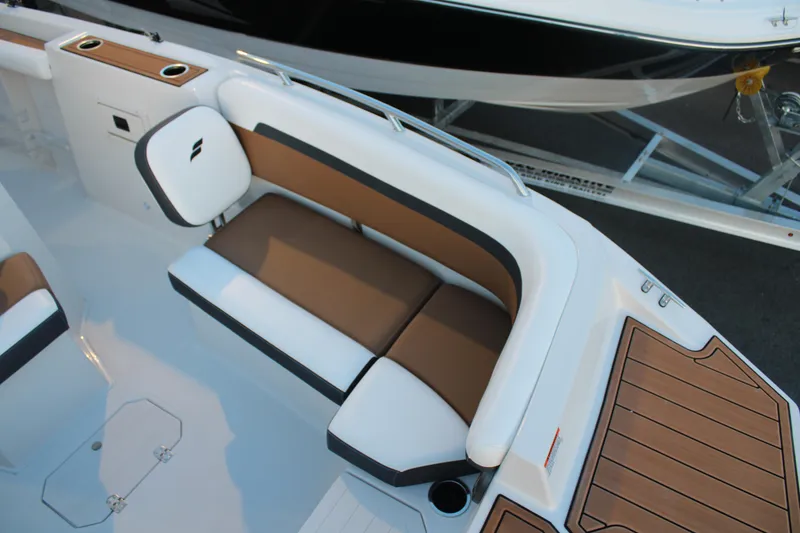 Slide: The Image of 2024 Starcraft SVX 211 OB CC boat interior with brown and white seating. - 10