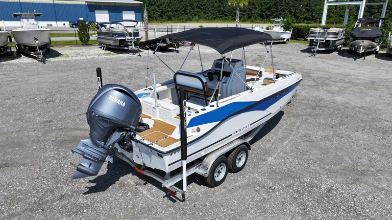 Slide: The Image of 2024 Starcraft SVX 211 OB CC boat with Yamaha outboard motor on trailer. - 2