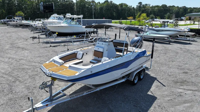 Slide: The Image of 2024 Starcraft SVX 211 OB CC boat on trailer in outdoor lot. - 3