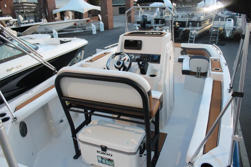 Slide: The Image of 2024 Starcraft SVX 211 OB CC boat interior with helm, seating, and Igloo cooler. - 7