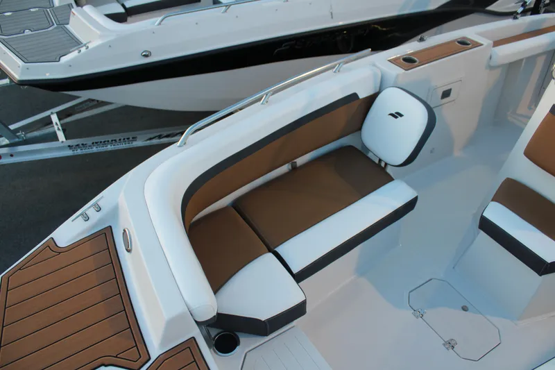 Slide: The Image of 2024 Starcraft SVX 211 OB CC boat interior with cushioned seating and sleek design. - 9