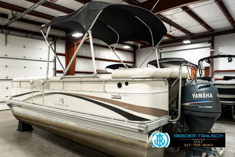 Slide: The Image of 2003 Bennington 2050 RL pontoon boat with Yamaha outboard motor in a storage facility. - 10