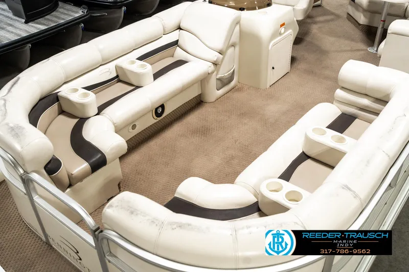 Slide: The Image of 2003 Bennington 2050 RL pontoon boat interior with plush seating and cup holders. - 12