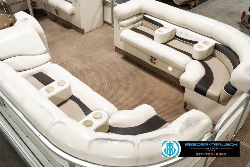 Slide: The Image of Interior of 2003 Bennington 2050 RL pontoon boat with plush seating and cup holders. - 13