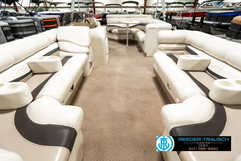 Slide: The Image of 2003 Bennington 2050 RL pontoon boat interior with spacious seating and beige upholstery. - 16