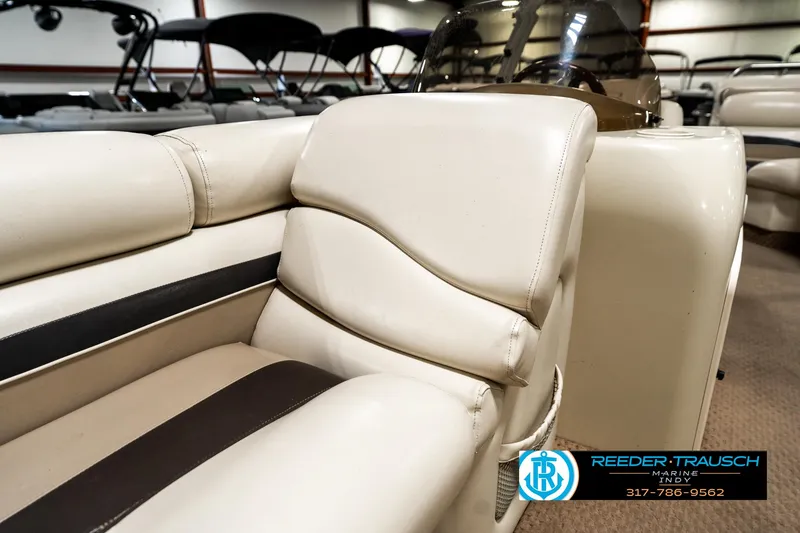 Slide: The Image of 2003 Bennington 2050 RL boat interior with beige seating, showcased at Reeder-Trausch Marine. - 24