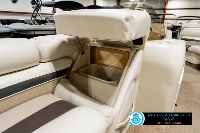 Slide: The Image of 2003 Bennington 2050 RL boat seat with storage compartment open, showcasing interior space. - 25