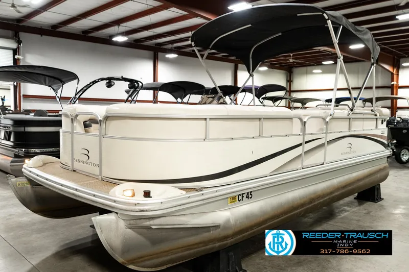 Slide: The Image of 2003 Bennington 2050 RL pontoon boat in indoor showroom with canopy. - 3