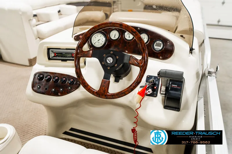 Slide: The Image of Steering console of a 2003 Bennington 2050 RL boat with wood accents and gauges. - 30