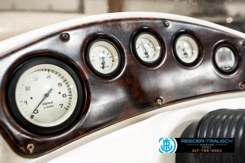 Slide: The Image of Dashboard of a 2003 Bennington 2050 RL boat with gauges and wood finish. - 35