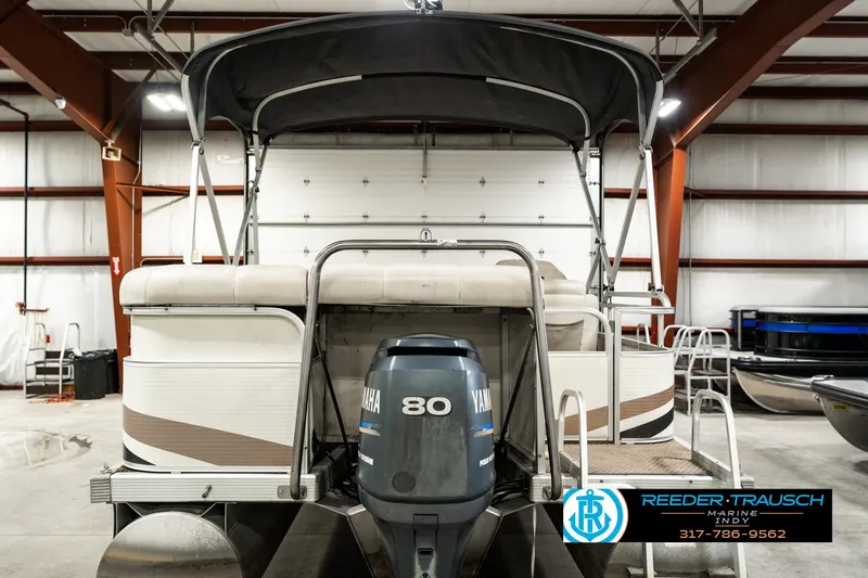 Slide: The Image of 2003 Bennington 2050 RL pontoon boat with Yamaha 80 engine in indoor storage. - 9