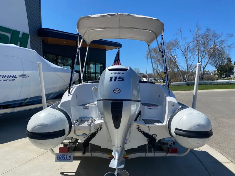 Slide: The Image of 2021 Walker Bay Generation 525 DLX boat with Honda 115 engine, parked outdoors. - 10