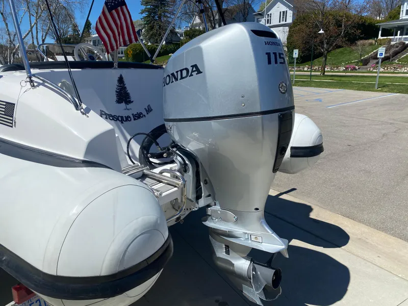 Slide: The Image of Walker Bay Generation 525 DLX 2021 with Honda 115 outboard motor, docked on a sunny day. - 12