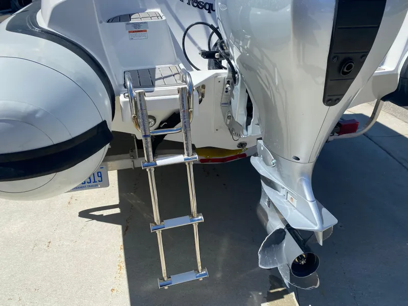 Slide: The Image of Walker Bay Generation 525 DLX 2021 boat with ladder and outboard motor detail. - 13