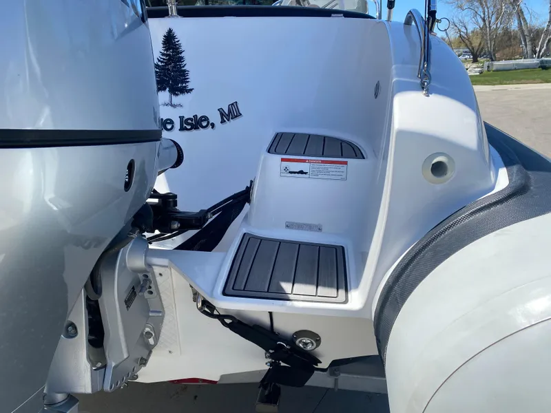 Slide: The Image of 2021 Walker Bay Generation 525 DLX boat stern with motor and step detail. - 18