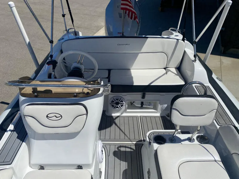 Slide: The Image of 2021 Walker Bay Generation 525 DLX boat interior with seating and steering wheel. - 21
