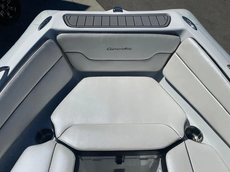 Slide: The Image of 2021 Walker Bay Generation 525 DLX boat interior with white cushioned seating. - 23