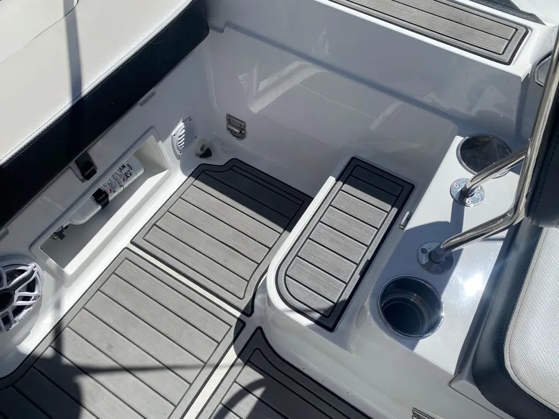 Slide: The Image of 2021 Walker Bay Generation 525 DLX boat interior with seating and cup holders. - 25