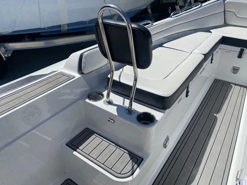 Slide: The Image of 2021 Walker Bay Generation 525 DLX boat interior with seating and cup holders. - 27