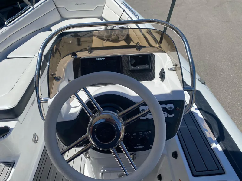 Slide: The Image of 2021 Walker Bay Generation 525 DLX boat steering console with modern controls and sleek design. - 29