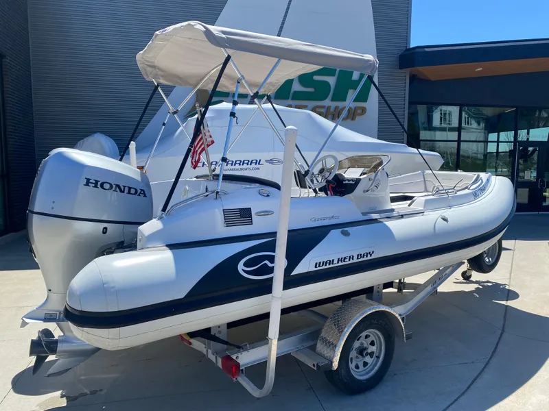 Slide: The Image of 2021 Walker Bay Generation 525 DLX boat on trailer with Honda outboard motor. - 4