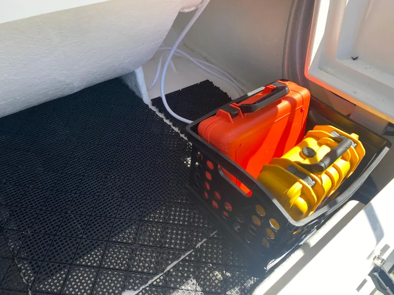 Slide: The Image of Storage compartment in 2021 Walker Bay Generation 525 DLX with orange and yellow cases. - 40